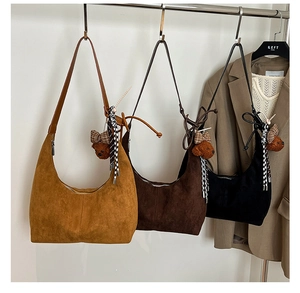 Three suede crescent shoulder bags in tan, brown and black with cute bear charms