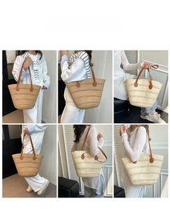 Detail of hand-woven striped tote bag with brown leather shoulder straps and rivets