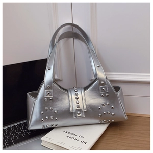 Close-up detail of silver metallic underarm bag with decorative rivet studs and buckle