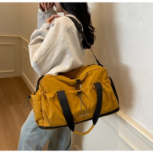 Detail of yellow gym bag with NINDOUA logo and separate bottom shoe compartment