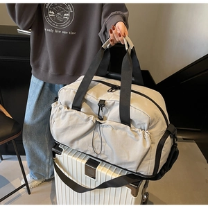 Detail of multi-pocket travel bag showing durable fabric and adjustable shoulder straps