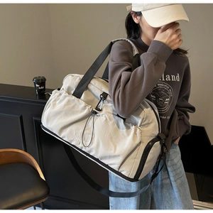 Detail of light beige waterproof fitness bag with adjustable strap and NINGIA print