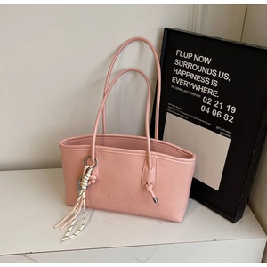 Close-up of pink tote bag with MIKAXIQI BAG FASHION embossed texture and woven strap