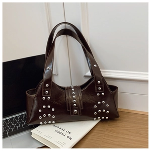 Detailed macro of dark brown glossy patent leather texture and silver metallic rivets