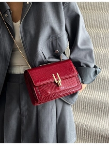 Dark red crocodile embossed leather chain bag with a polished golden buckle