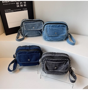 Detailed view of four retro denim crossbody bags in varied washes with double zippers