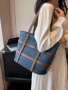 Vintage denim tote bag with brown leather straps and gold rivets for women