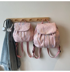 Detailed comparison of pink quilted backpacks in small and large sizes with embroidery