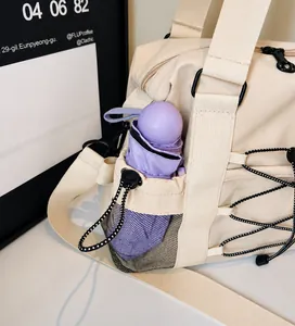 Detail of nylon bag side mesh pocket holding a purple umbrella for travel convenience