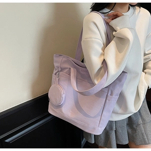 Detail of lavender canvas tote with matching round coin purse and JUMAN brand logo