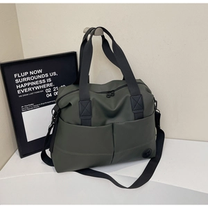 Detail view of large dark green travel bag with water-resistant fabric and matte strap