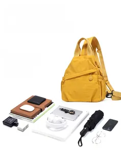 Detail of yellow nylon backpack showing large capacity for 15.6 inch laptop and accessories