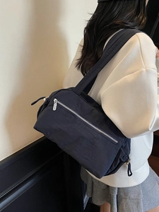 Minimalist large capacity nylon tote bag with metal zipper and side drawstring detail