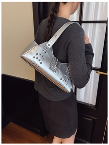 Silver metallic underarm shoulder bag with rivet studs in a modern biker style