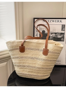 Beige woven straw tote bag with brown leather handles for summer beach vacations