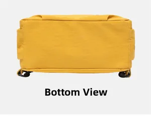Detail view of the flat bottom structure and stitching of a yellow commuter backpack
