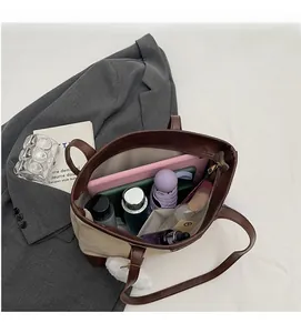 Interior view of large capacity canvas tote bag showing storage for tablet and umbrella
