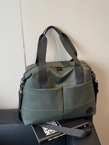 Olive green large capacity travel tote bag with double front pockets and black handles