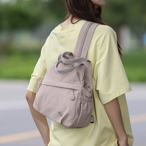 Detail showing versatile lavender nylon backpack with zip-convertible shoulder strap