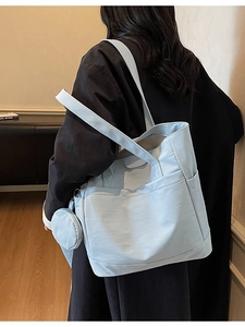 Light blue canvas tote bag with side pockets and matching mini coin purse charm for women