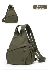 Detail view of olive green waterproof nylon chest bag with zip pockets and metal logo