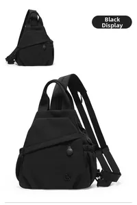 Close-up of black nylon triangular sling bag with zipper pockets and side drawstring
