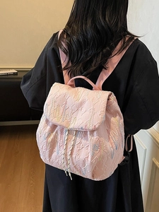 Pink quilted backpack for women featuring colorful wave embroidery and casual style
