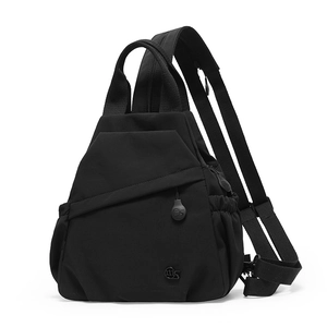 Detail of versatile black nylon backpack with convertible zipper strap and side pocket