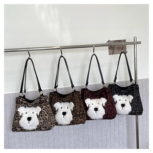 Detail of leopard print tote bags featuring plush puppy applique and zipper closure