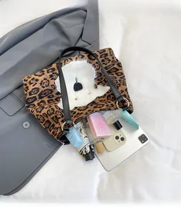 Spacious leopard print tote bag interior showing umbrella, makeup, and tablet storage