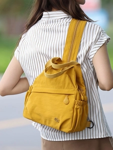 Lightweight yellow nylon multifunctional backpack for women featuring multiple pockets