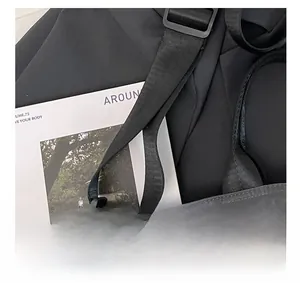 Detailed macro view of the black nylon shoulder strap with adjustable plastic buckle
