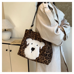 Close-up of leopard print tote bag featuring white plush puppy embroidery and black straps