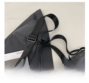 Close-up of adjustable shoulder strap and buckle on a waterproof nylon tote bag