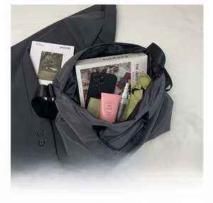 Detailed interior of a dark grey nylon tote bag showing spacious storage for daily items
