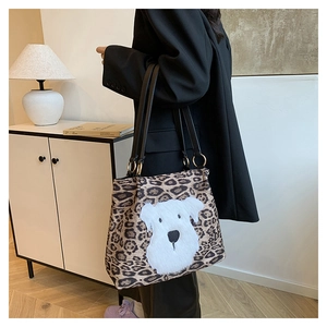 Macro detail of leopard print tote bag featuring a large white schnauzer dog face graphic