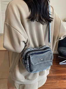 Chic denim blue crossbody bag for women featuring vintage washed fabric and silver hardware