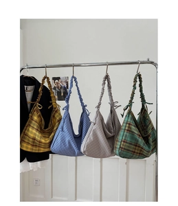 Detail of checkered hobo bags in four colors with ruffled drawstring shoulder straps