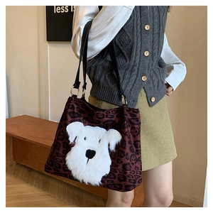 Leopard print tote bag with plush dog patch shown worn on shoulder for size and fit