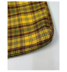 Close-up of high-quality woven plaid fabric and stitching on a vintage shoulder bag