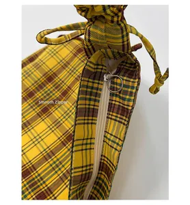 Detail of vintage plaid tote bag with smooth silver metal zipper and ring puller