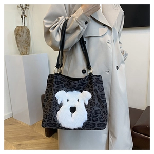 Leopard print knit tote bag with plush dog patch and black straps with gold rings