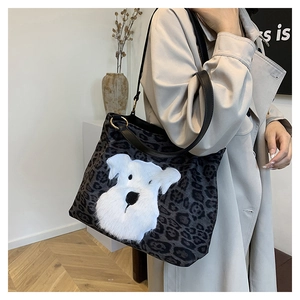 Close-up of leopard print tote bag featuring a 3D plush dog patch and leather straps
