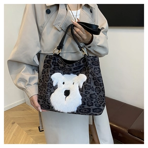 Detailed view of leopard print tote bag with plush puppy patch and leather handles