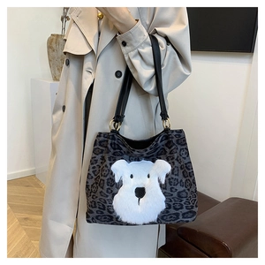 Detail of leopard print tote bag with plush schnauzer patch and black leather straps