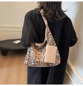 Detail of leopard print tote bag with attached beige mini card pouch accessory
