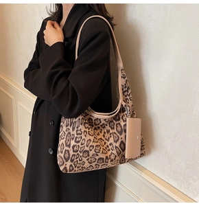 Detail view of large leopard print hobo bag with matching mini pouch and leather strap