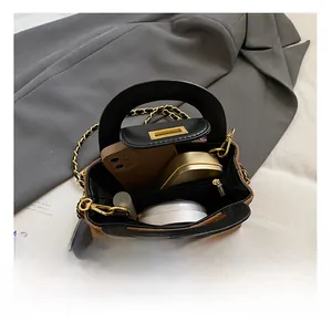 Internal view showing capacity of the brown quilted leather crossbody bag with items