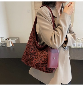 Detail of red leopard print tote bag with small matching purse worn over the shoulder