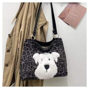 Detail of leopard print tote bag featuring a white plush schnauzer puppy patch